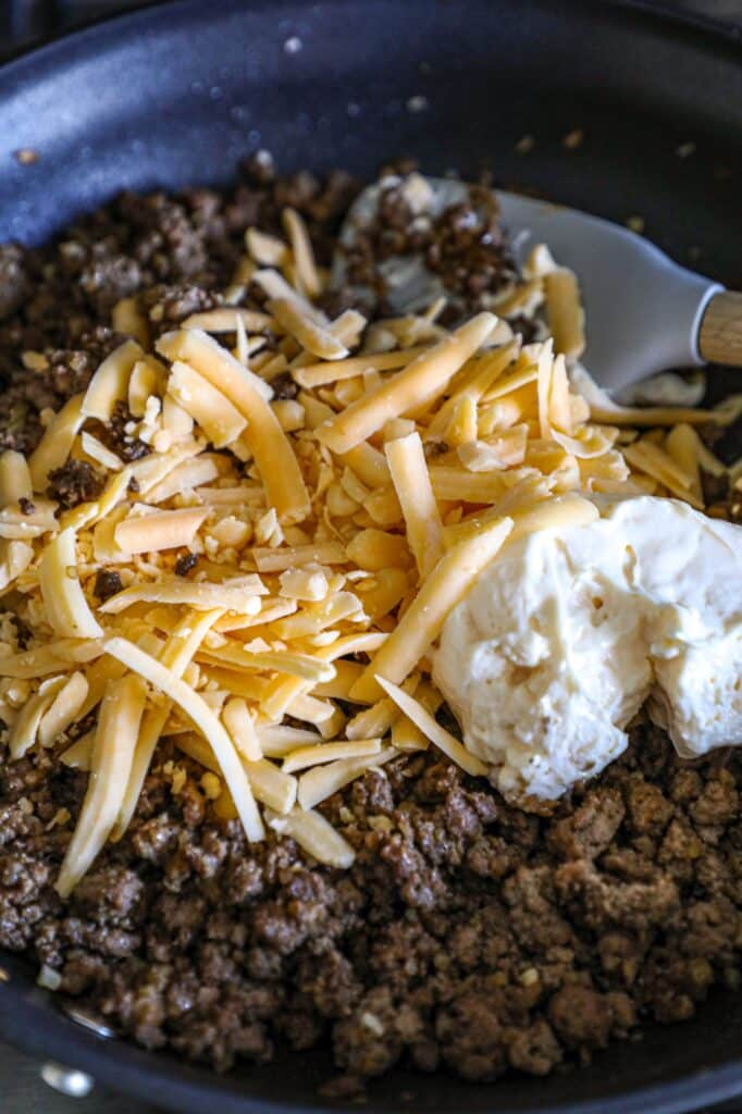 Cooked hamburger meat with the shredded cheese and mayo binder added