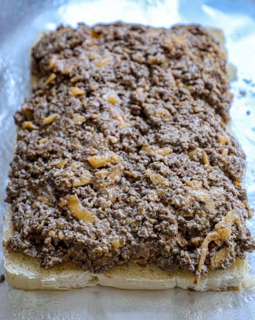 Burger mixture added to the bottom buns