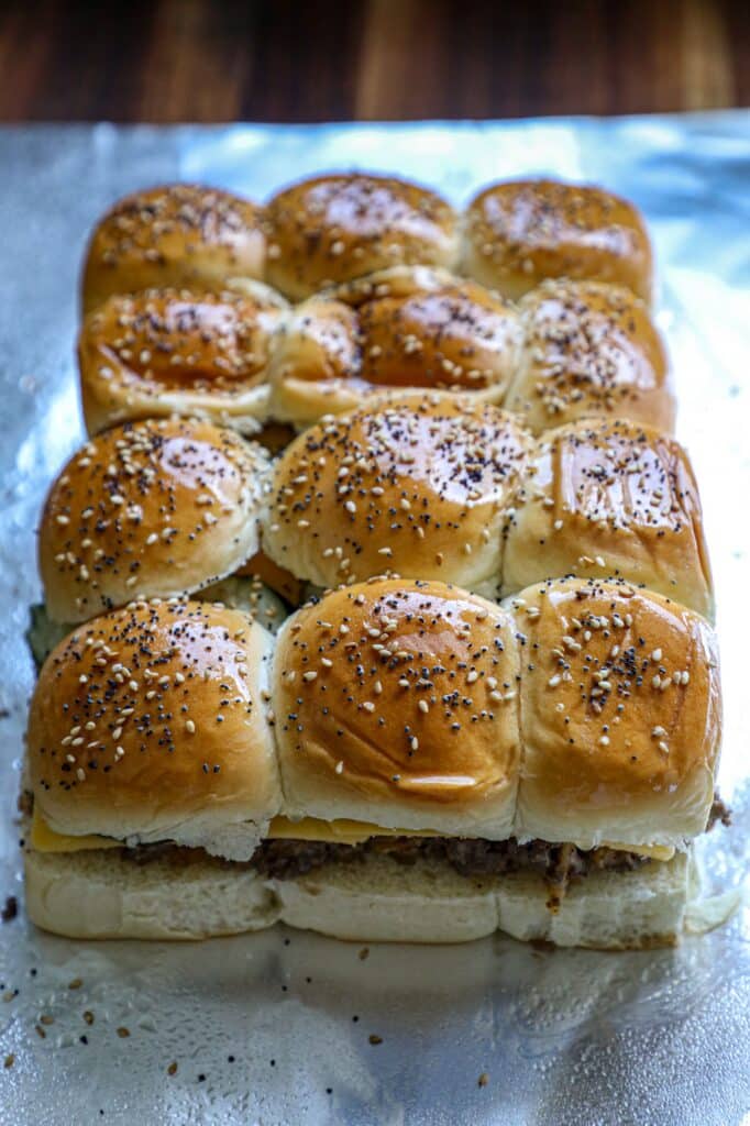 Top bun added with sesame and poppy seeds ready for the oven