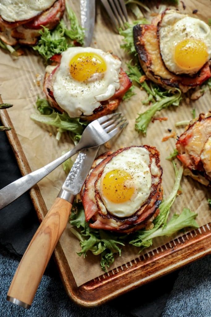 Six open faced keto croque madame on a tray.