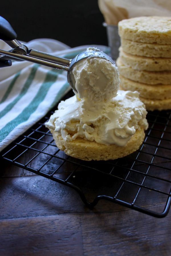 A piece of cake sitting on top of a table with ice cream on it. 