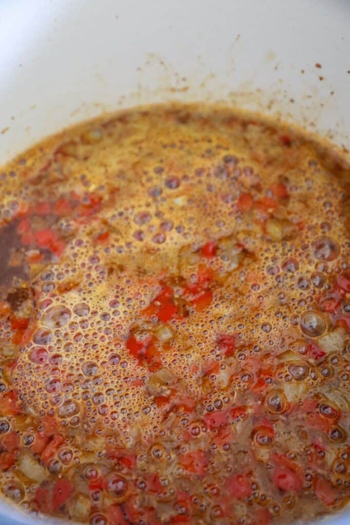 adding the beer to the soup to cook off