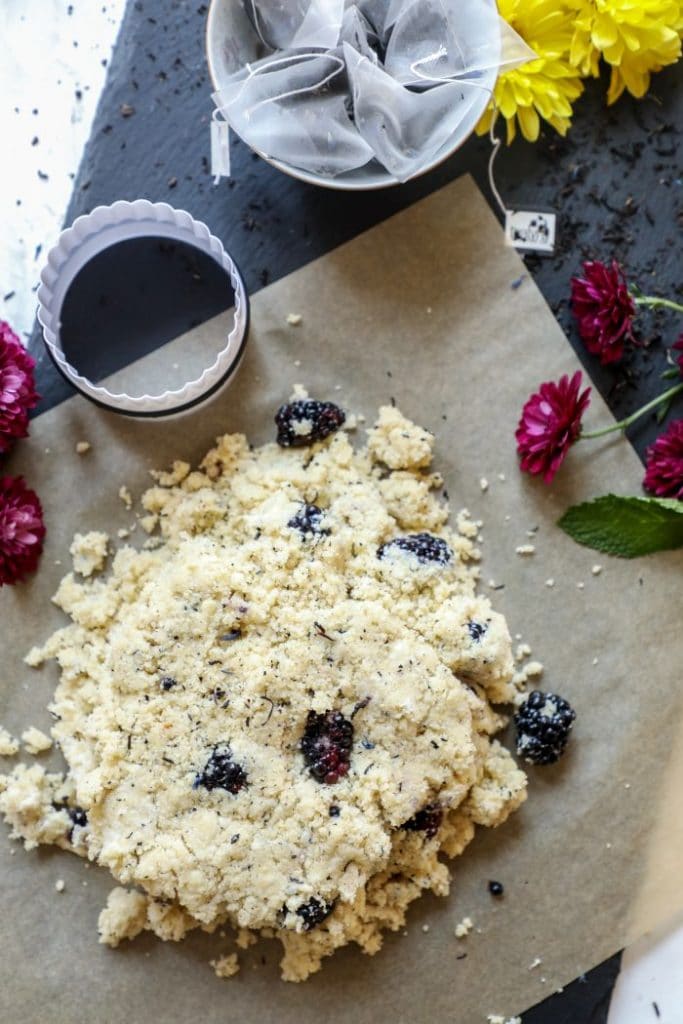 Scone dough dumped out onto parchment paper.