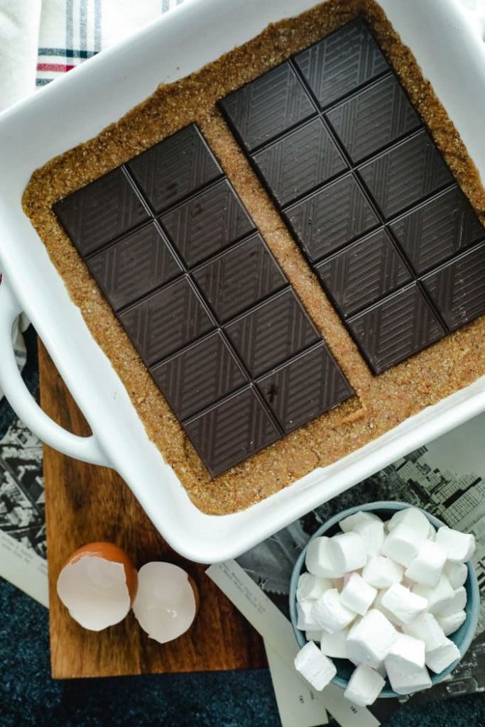 Chocolate bars placed over the baked crust