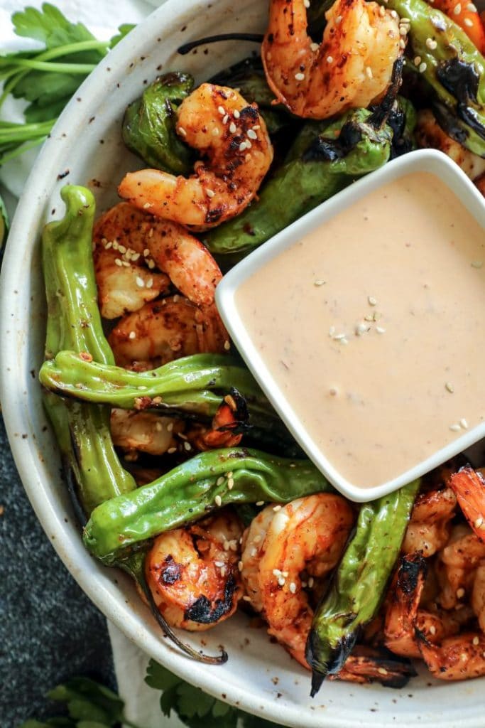 A plate of food with sesame sauce, Shrimp and Shishito