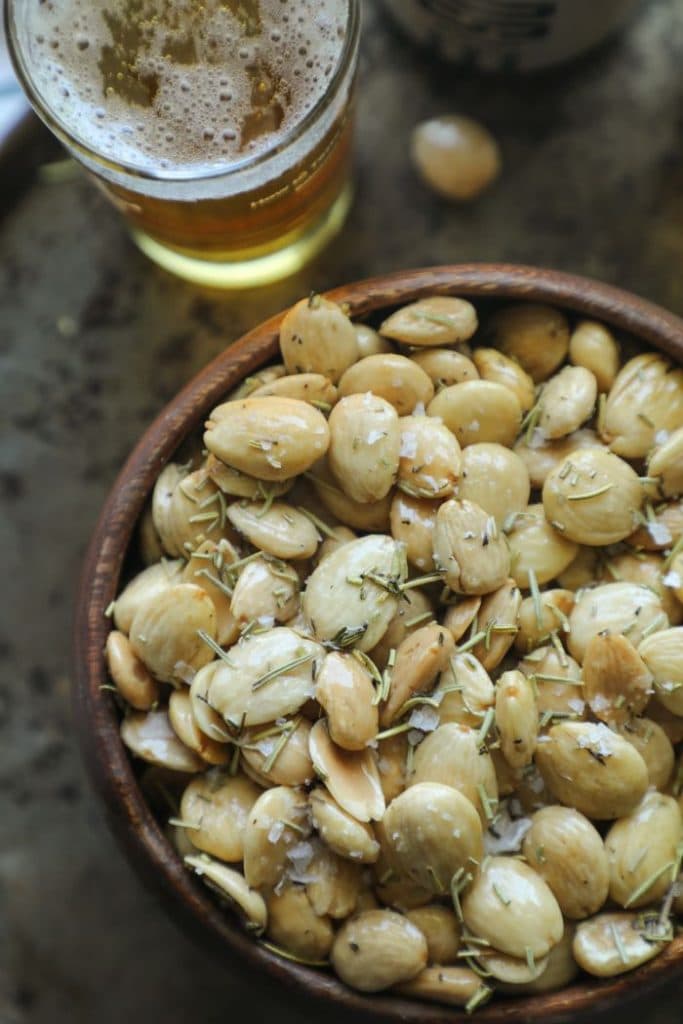Close up of a bowl of the smoked marcona almond with herbs