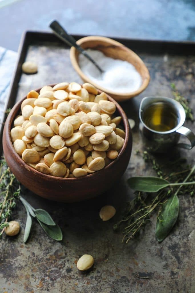 Raw Marcona Almonds in a brown bowl.