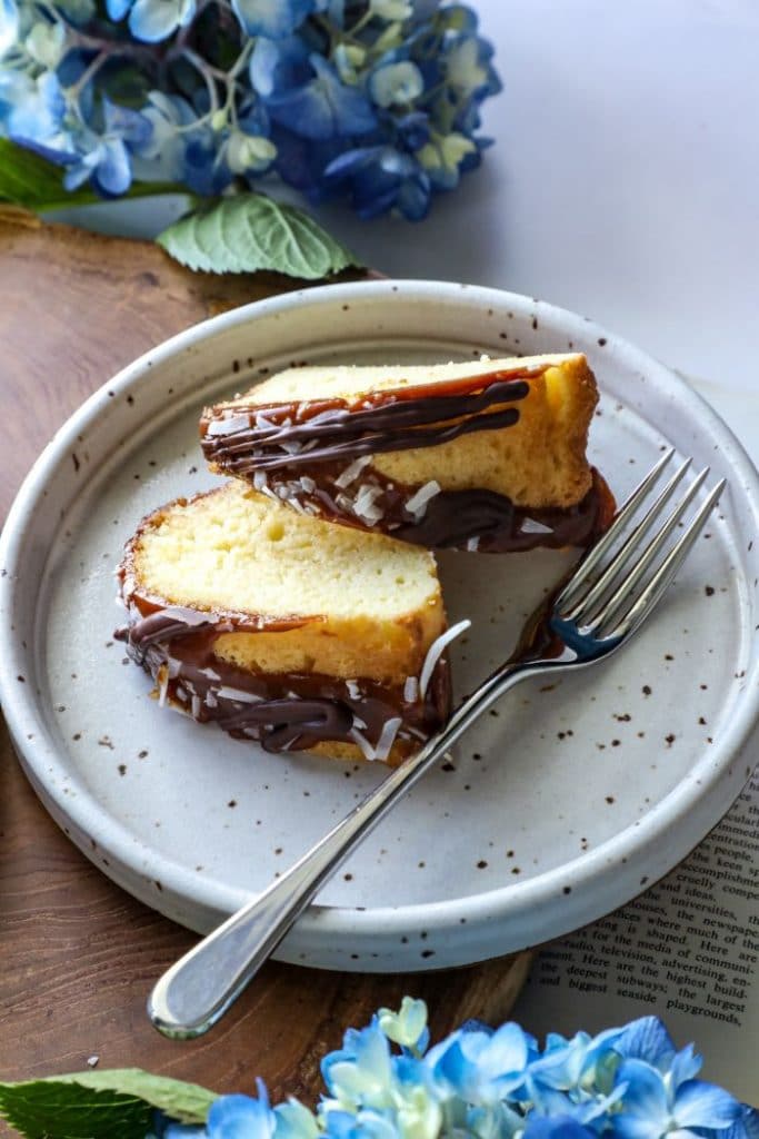 Two slices of keto samoa bundt cake on a plate with a fork.