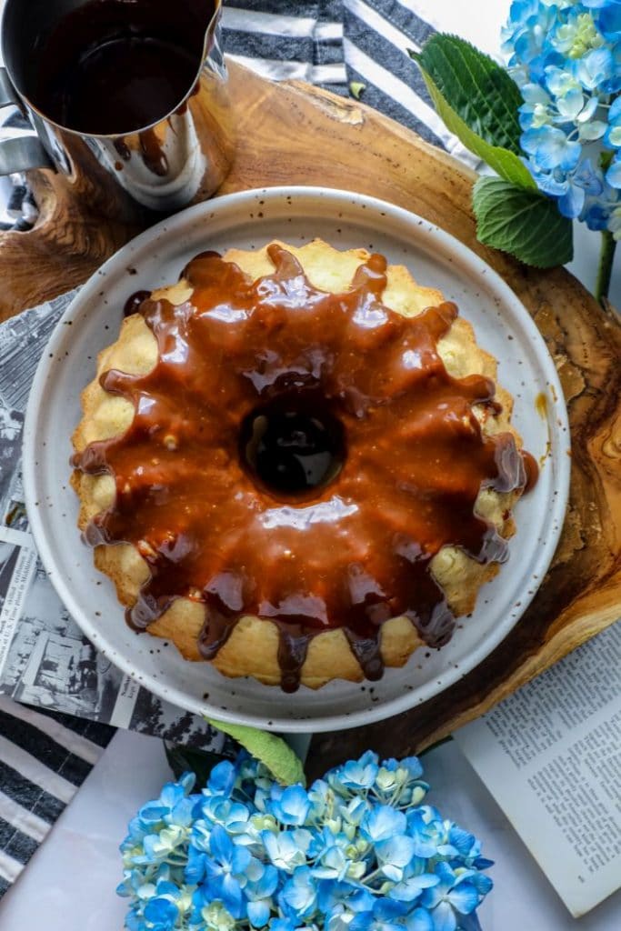 Keto caramel coated bundt cake on a plate.