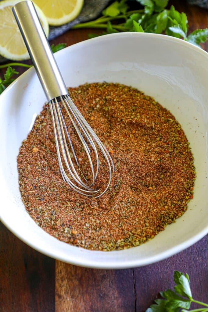 adding the spices to a bowl and combing them into a blend