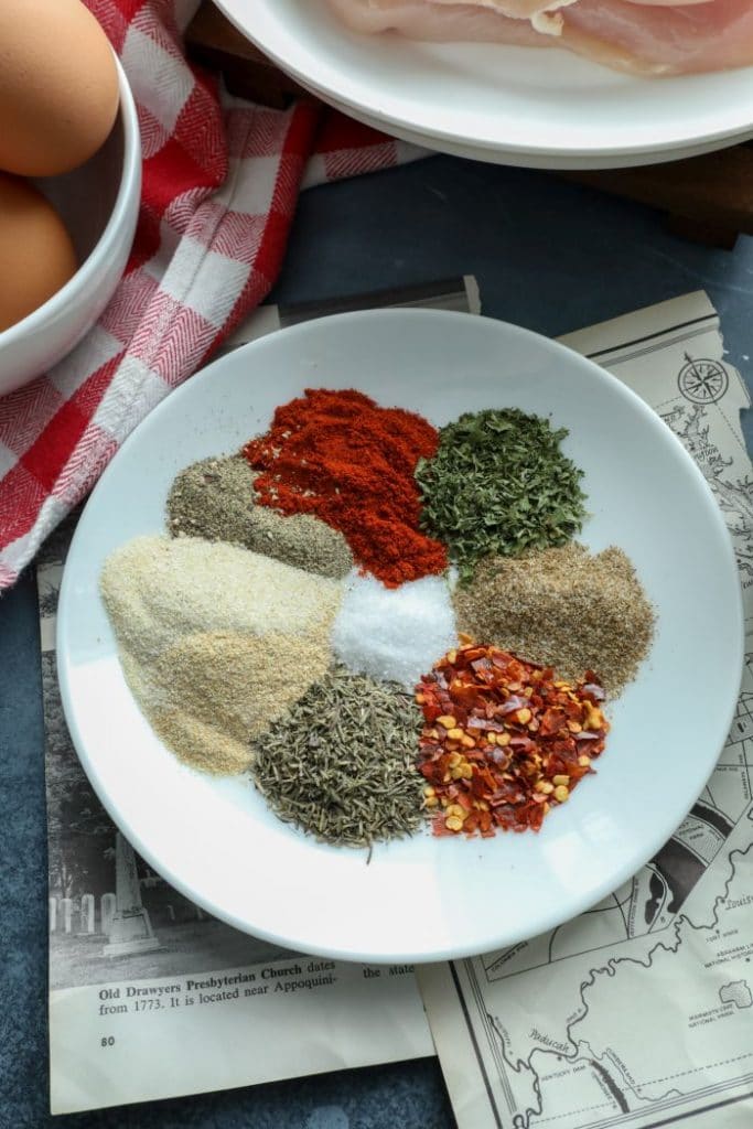 Spicy Cajun BBQ Dry Rub spices all on a white plate. Recipe