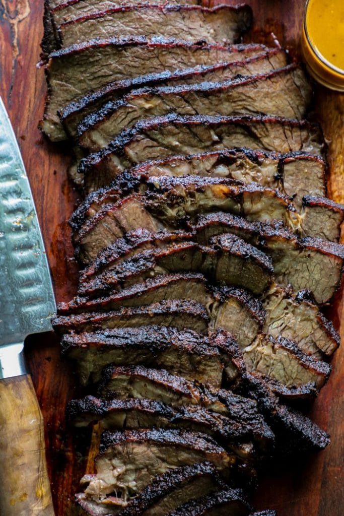 Sliced smoked chuck roast on a cutting board