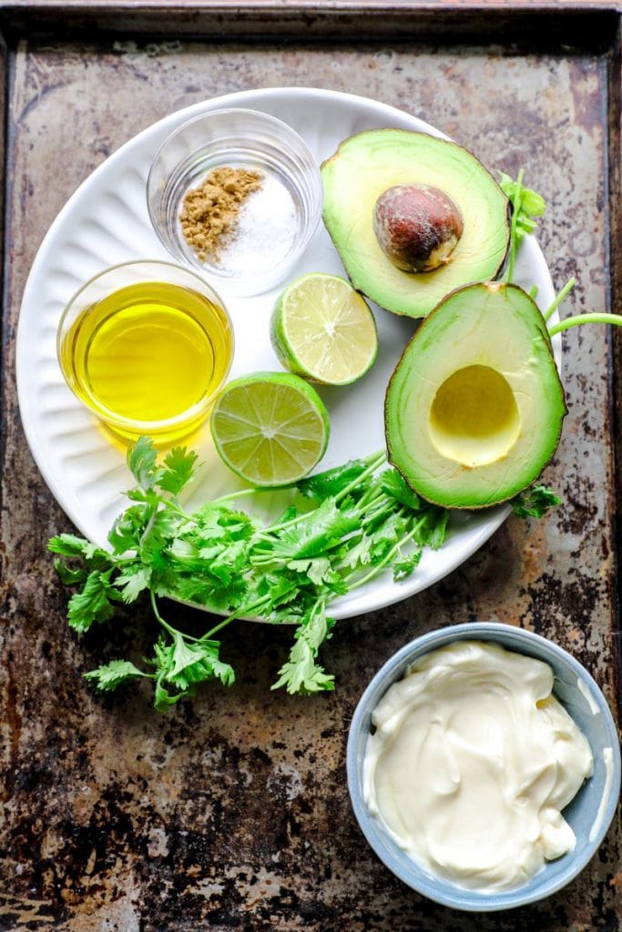 Avocado dressing ingredients on a white plate