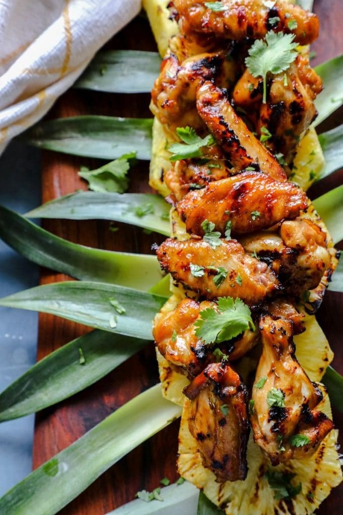 Hot Honey Hawaiian Wings on grilled pineapple