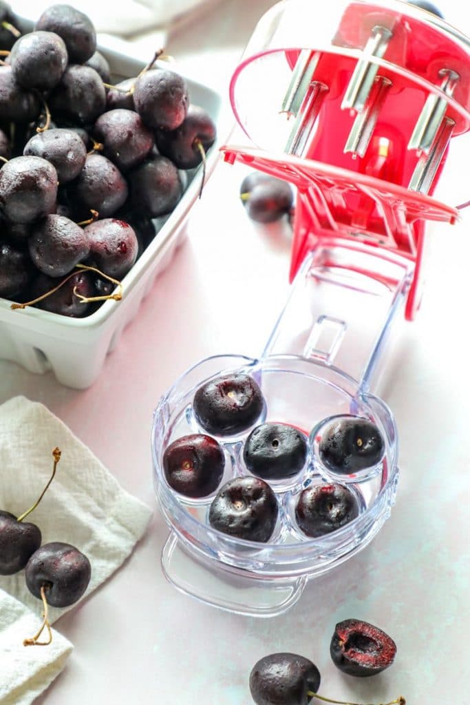 Using a cherry pitting tool to pit cherries