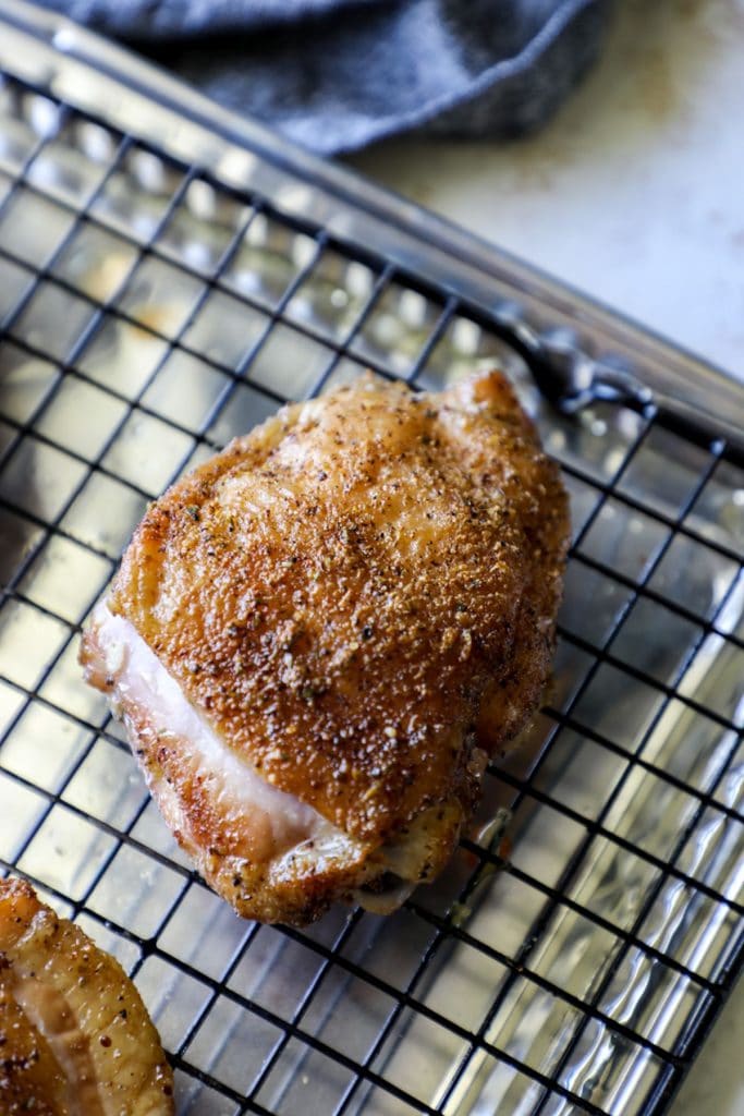 Smoked Chicken Thigh right off the grill on a cooling rack