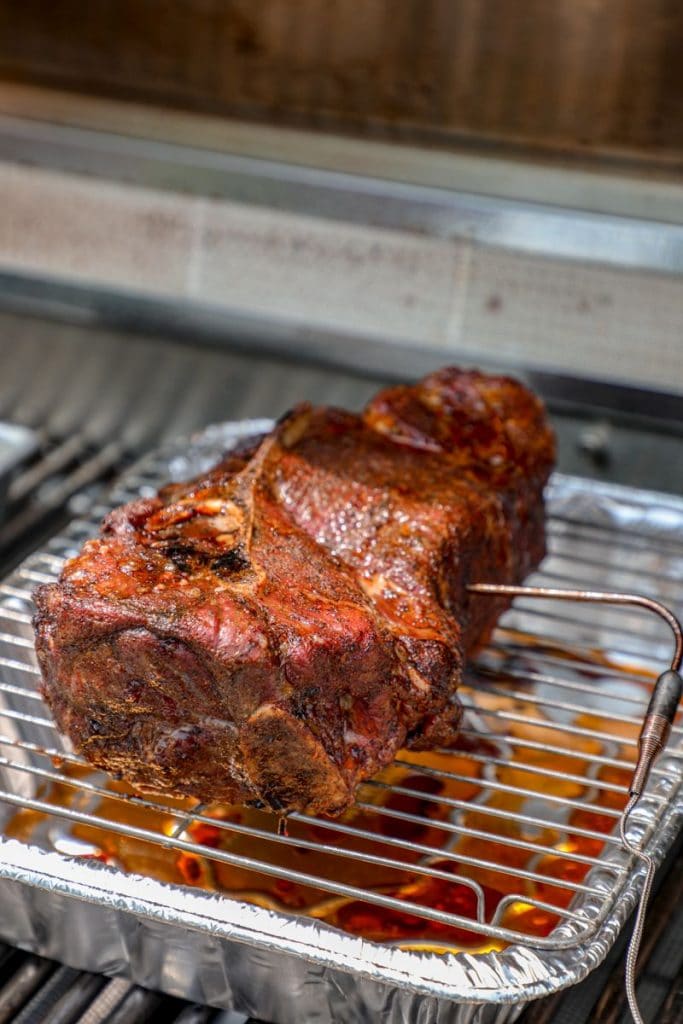 pork butt being smoked on the gas grill