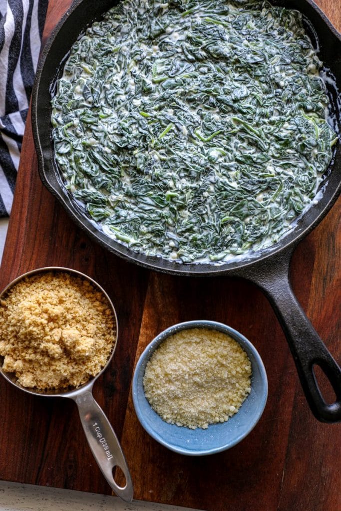 Creamed spinach prepped in a cast iron skillet