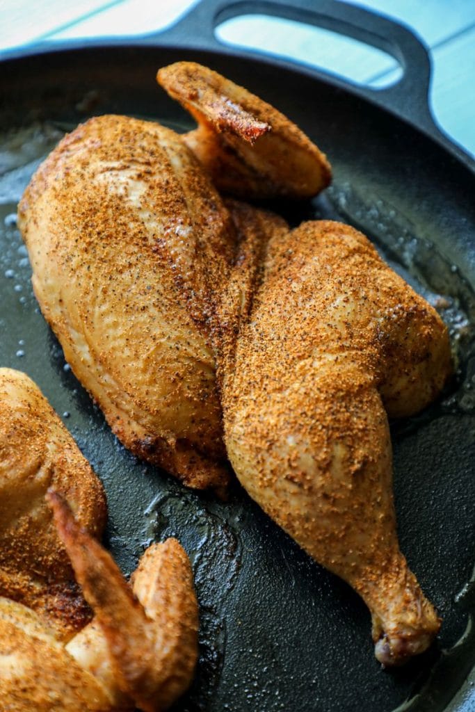 Smoked halved chicken ready to be pulled for BBQ