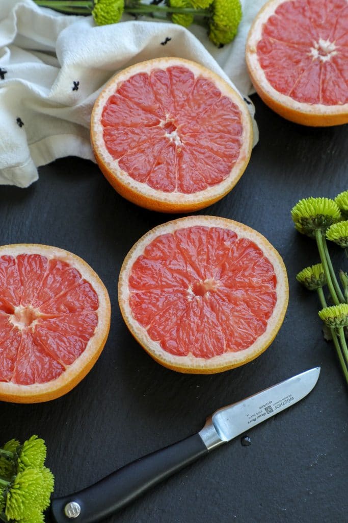 sliced grapefruits on a board