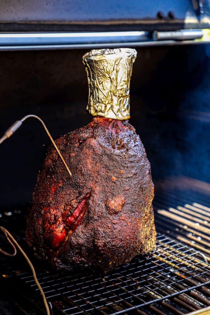 A beef shank being smoked on the grill