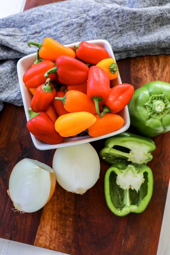 Bell peppers and onion on a cutting board