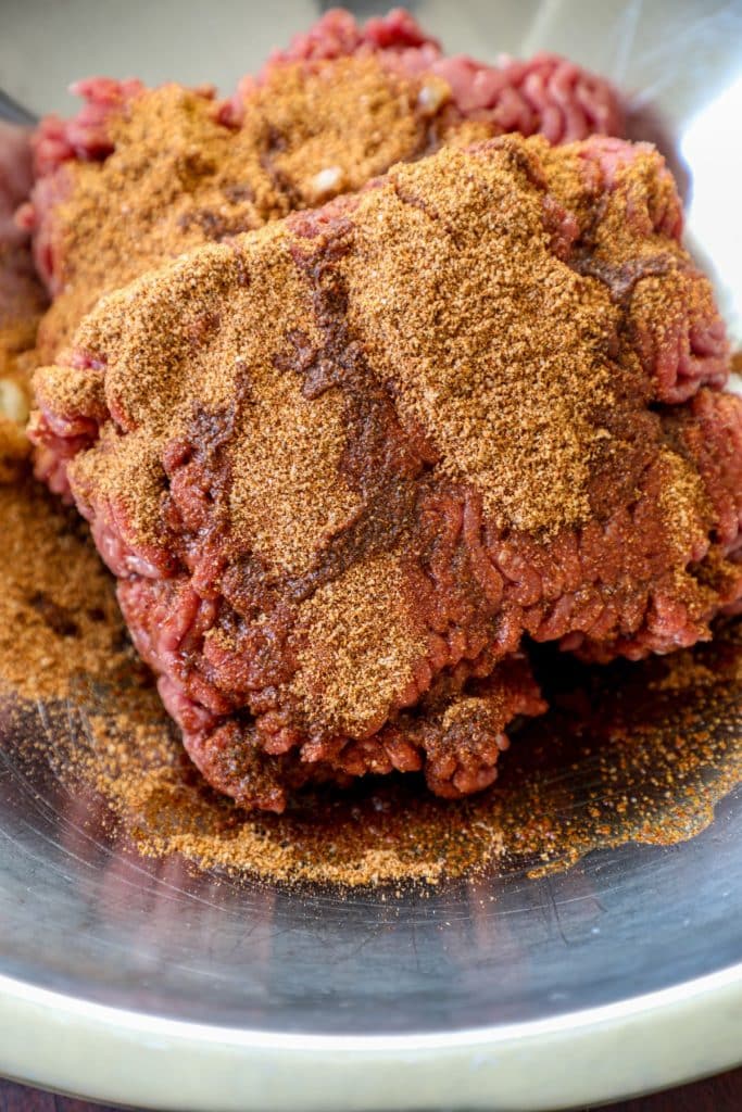 Seasoning the ground beef with chili seasoning