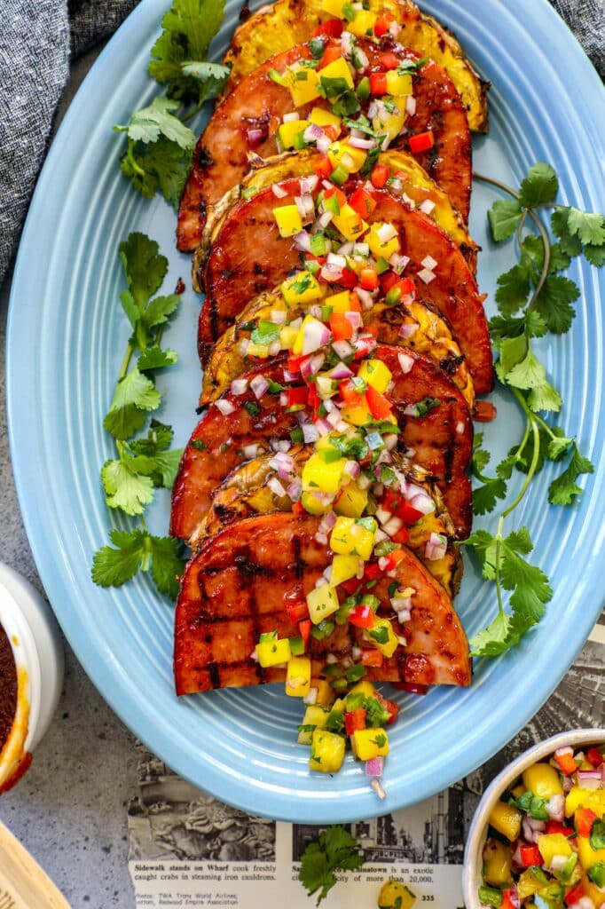 Why This Recipe Works:

Grilling ham slices instead of searing them indoors enhances the natural flavors of the meat and gives it a delicious smoky taste. The higher direct heat from the grill also helps to caramelize the sugars in the meat, creating a crispy crust on the outside while keeping the inside tender and juicy.

Additionally, while grilling allows for a quick and easy cooking process, making it a great option for busy weeknights or summer BBQs, it also aids in adding other layers of flavors (like seasoning with your favorite BBQ rubs or my pineapple BBQ sauce for example).

This recipe is also ideal for small families who want to enjoy ham for the holidays without having so much excess meat remaining. It can be an easier and more affordable option.