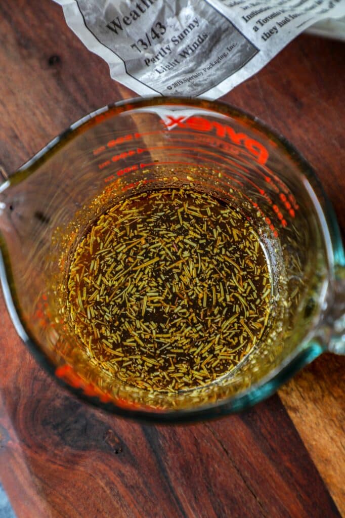 Montreal Steak Marinade Recipe ingredients mixed together in a glass measuring cup.