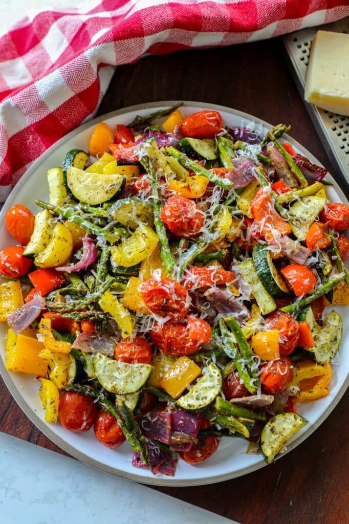 Italian Roasted Vegetables on a serving platter topped with parmesan cheese.