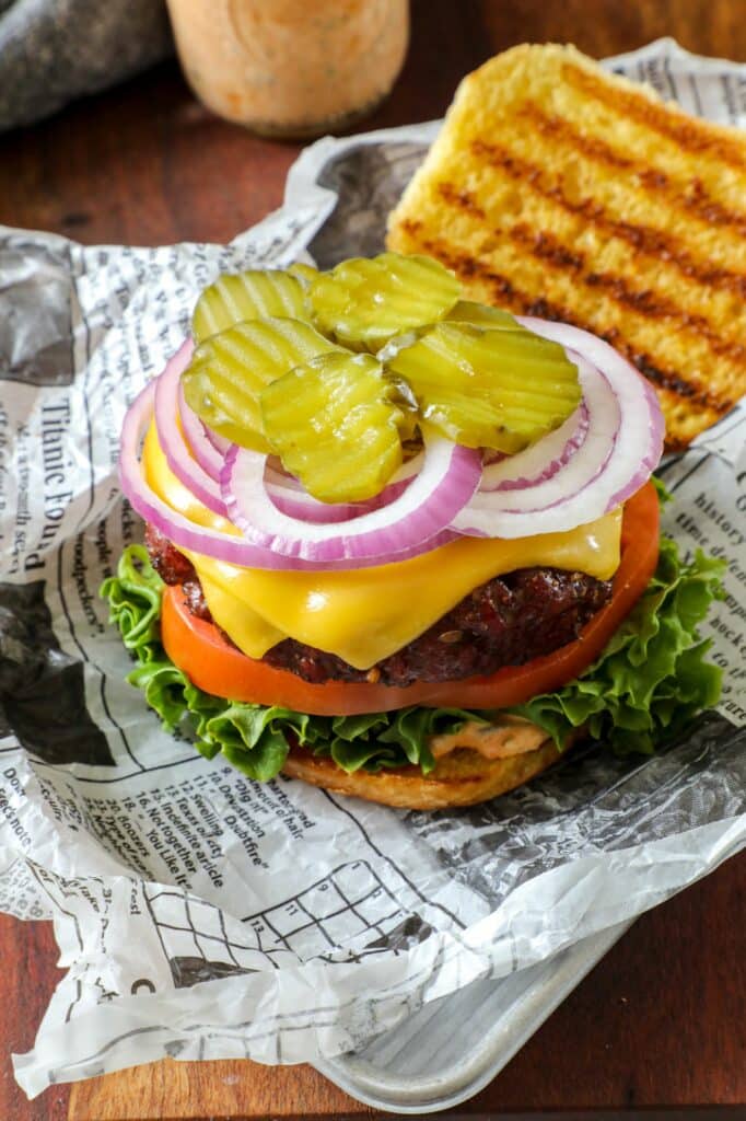 Burger with the top bun left off and all the burger toppings on top.