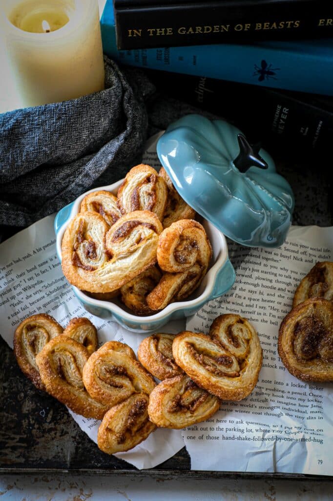 Pumpkin Butter Puff Pastry Palmiers in a pumpkin shaped dutch oven on newspaper.