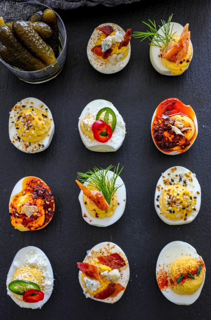 Overhead shot of Smoked Deviled Eggs with different toppings.