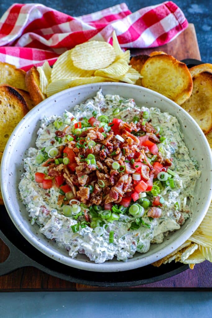 Smoked BLT Dip Recipe served in a serving bowl with chips and bread on the side.