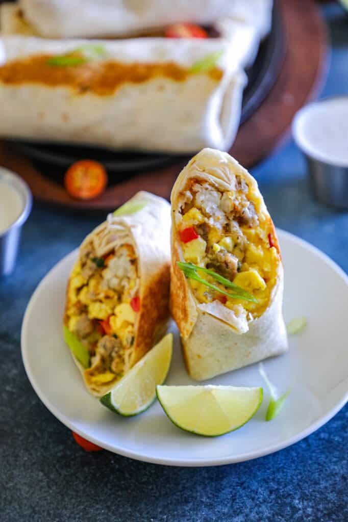 Homemade McDonald's Breakfast Burrito Recipe served on a plate with lime wedges.