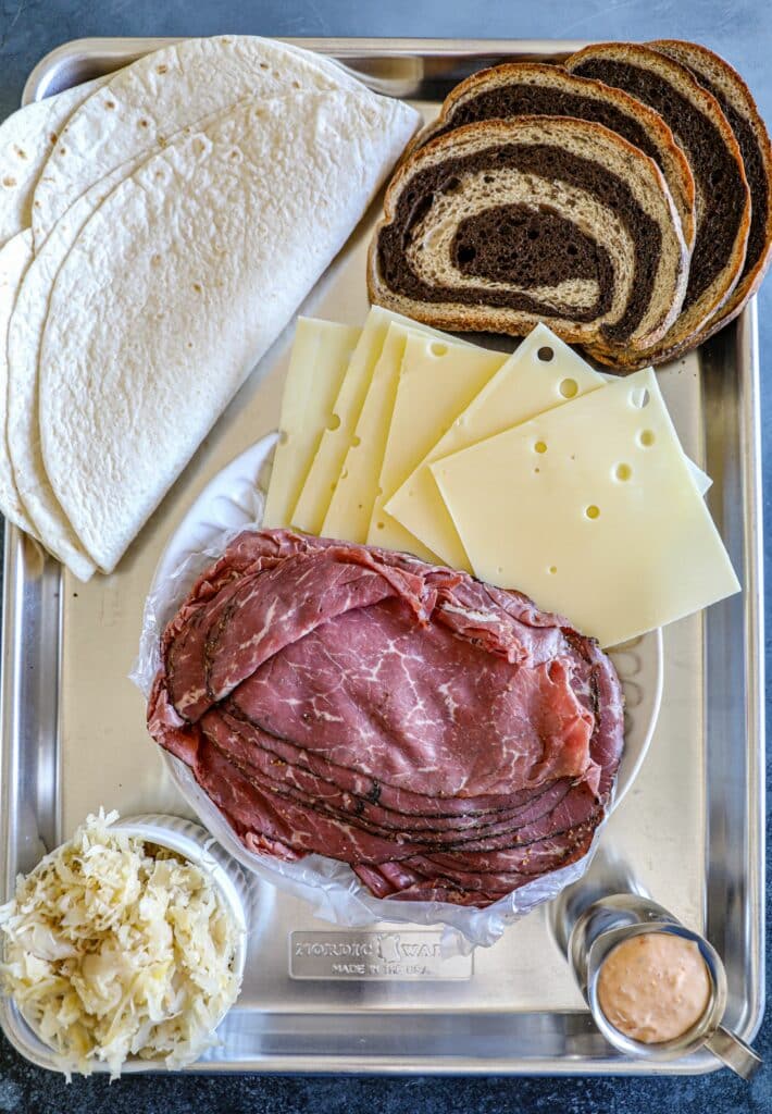 Reuben Crunchwrap ingredients on a tray