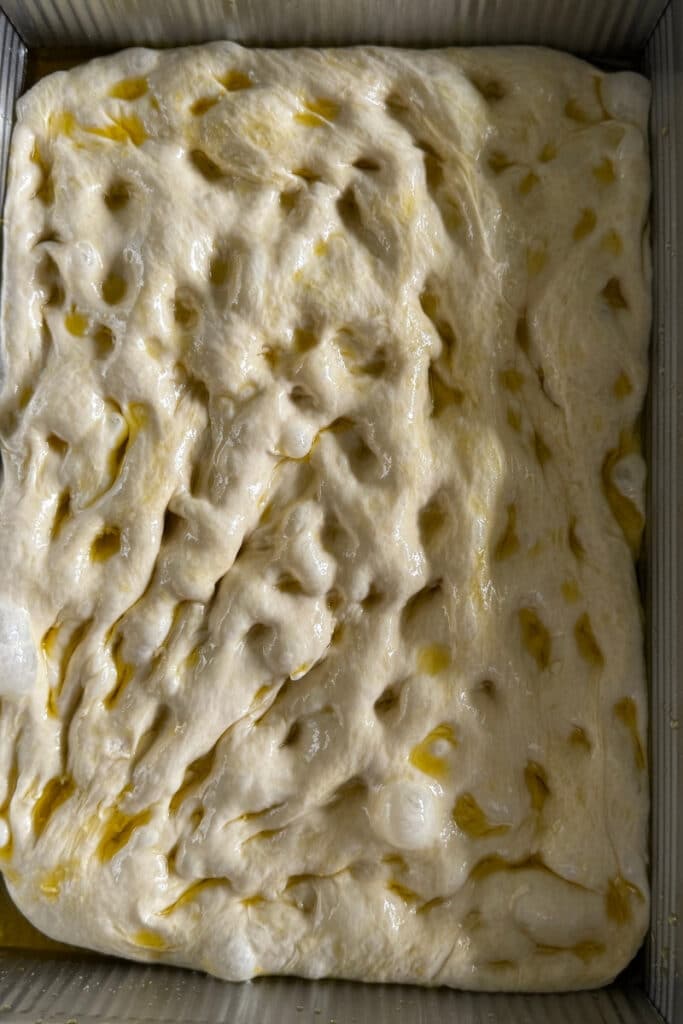 dimpling the focaccia dough