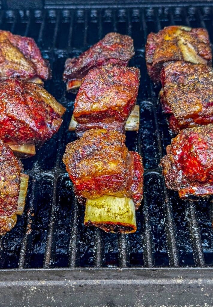 The smoking process on the grill with smoked beef short ribs