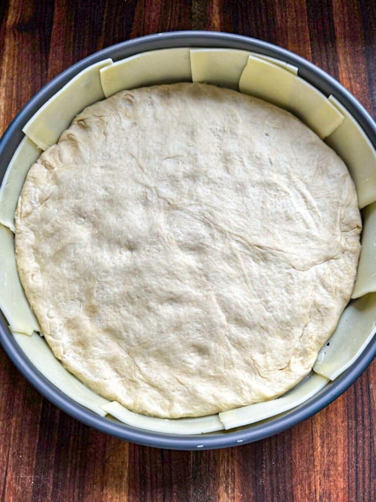 The dough added to the pan and pressed into it