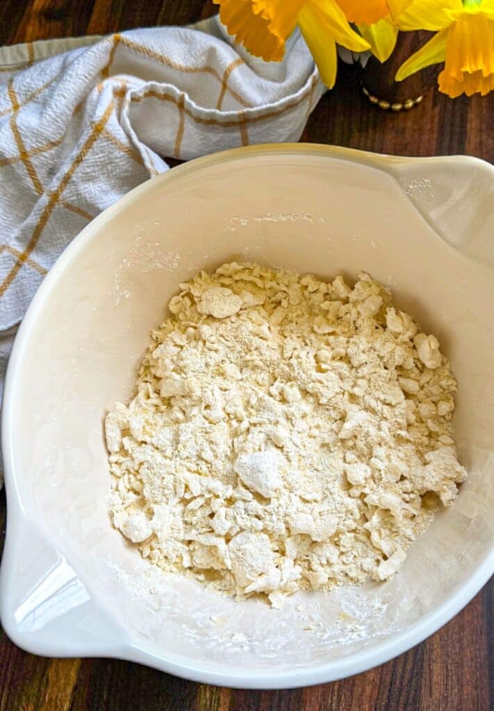 Adding the buttermilk to form a shaggy dough