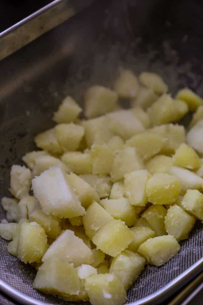 Roughing up the potatoes in a colander