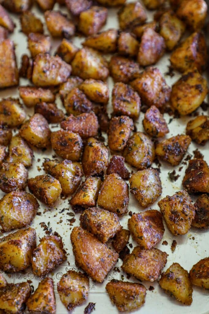 Roasting the country potatoes on a baking sheet