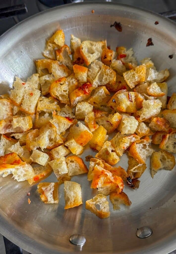 toasting small croutons in a pan