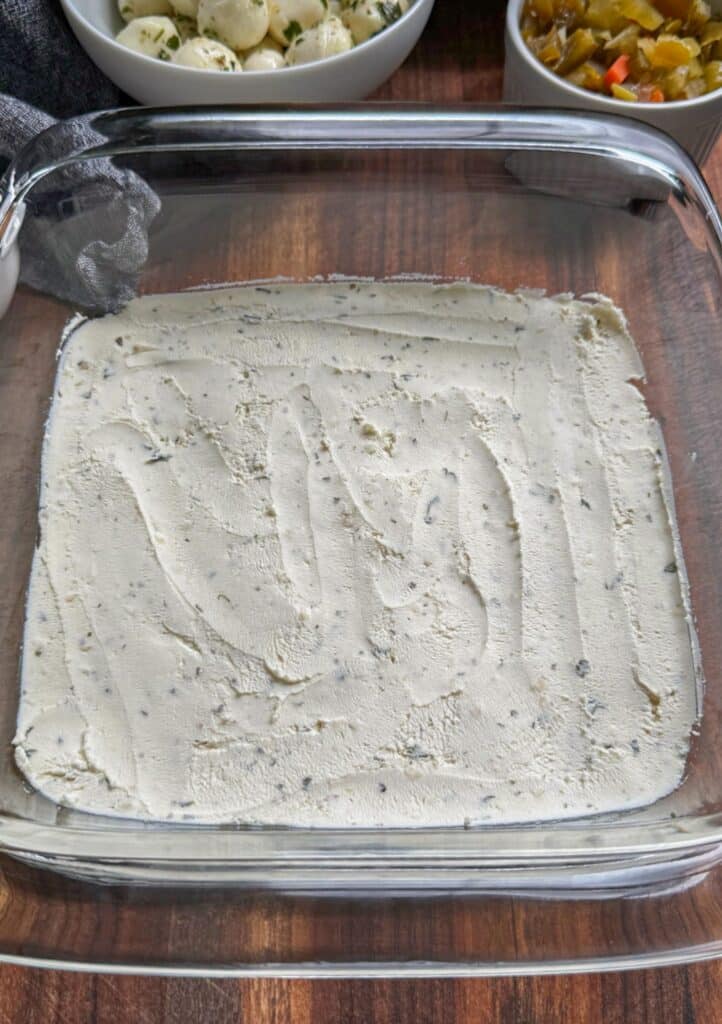 spreading the boursin cheese layer into the dish