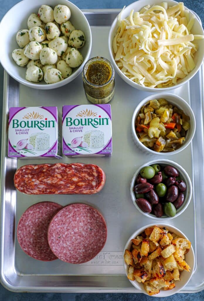 Charcuterie Dip ingredients on a pan
