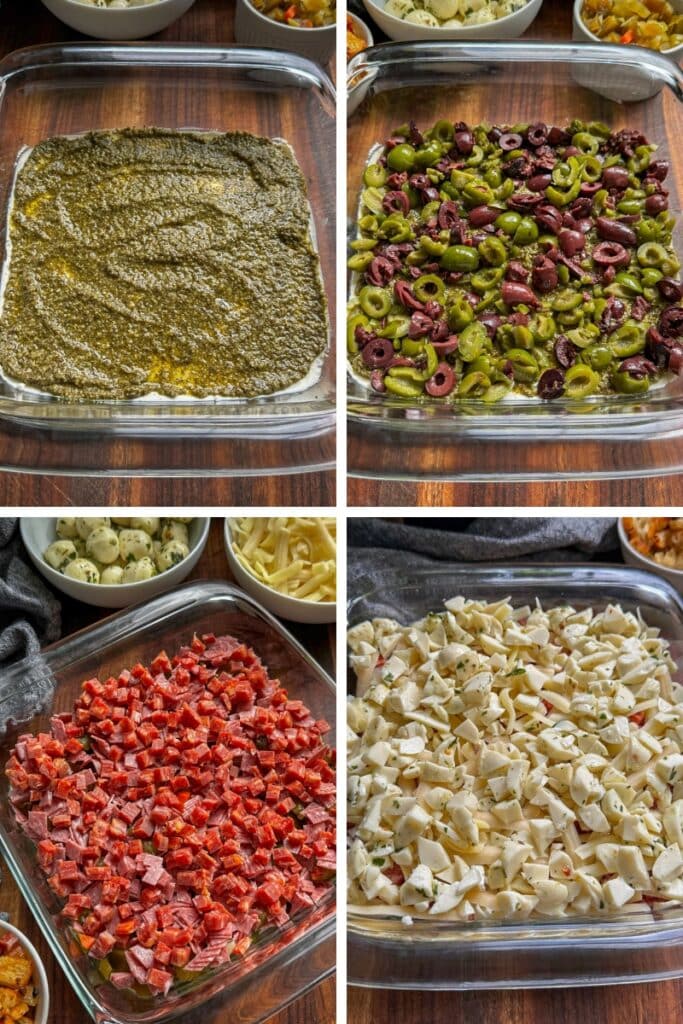 A photo of four different layers (pesto, then olives, meats, and the cheeses)