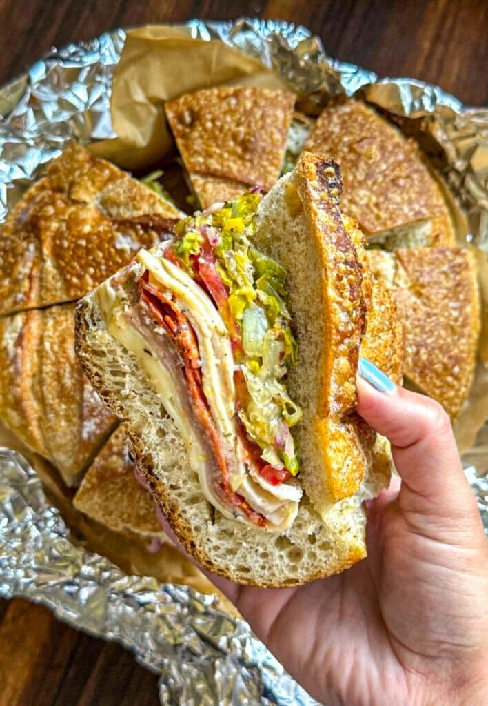 holding a wedge of the sandwich
