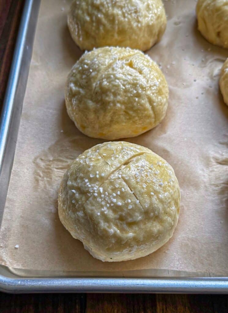 adding salt to the top of the buns