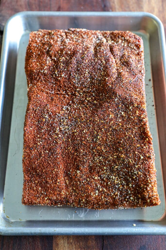 Pork belly with bbq rub on it prepped for the smoker