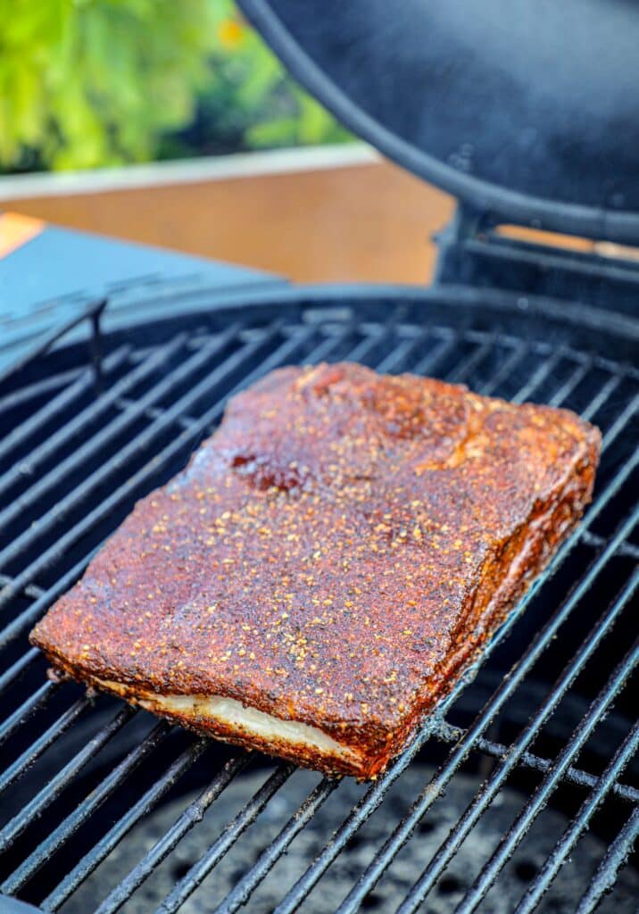 Smoking the pork belly slab on the drum smoker for 1-2 hours